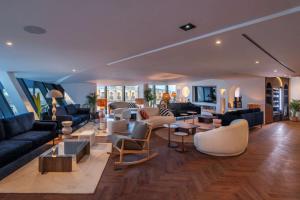 a living room with couches and chairs and tables at Doubletree By Hilton Nice Centre Iconic in Nice