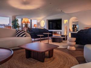 a living room with couches and a coffee table at Doubletree By Hilton Nice Centre Iconic in Nice