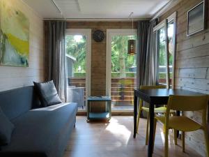 a living room with a couch and a table at Guldborg Camping & Cottages - Superior in Guldborg