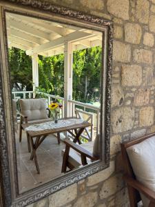 a mirror on a patio with a table and a chair at Taşdelen Hotel in Alaçatı +68 photos