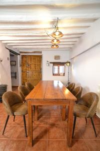 a dining room with a wooden table and chairs at Casa Rural en la Montaña Mas de Tenesa in Benasal +47 photos