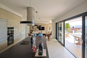 a kitchen with a sink and a counter top at Stylish Lumbarda Villa Sleeps 10 with Private Pool in Lumbarda