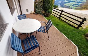 a table and chairs sitting on a deck with a view at Ferienwohnung In Hopfgarten in Hopfgarten im Brixental +11 photos