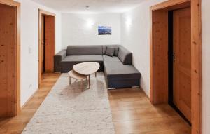 a living room with a couch and a table at Ferienwohnung In Hopfgarten in Hopfgarten im Brixental