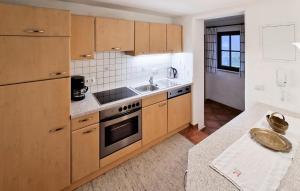 a kitchen with a sink and a stove at Ferienwohnung In Hopfgarten in Hopfgarten im Brixental