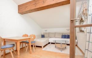 a living room with a couch and a table at Apartment Blick Hohen Salve in Hopfgarten im Brixental
