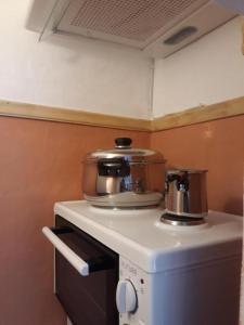 a coffee maker on top of a counter in a kitchen at Miranta Hotel - Apartments & Studios in Aegina Town