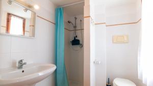 a bathroom with a sink and a shower at Villa Brezza di Mare-Geremeas Country Club in Maracalagonis +34 photos