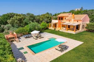 an aerial view of a house with a swimming pool at Villa Nostos by Villa Plus in Svoronata
