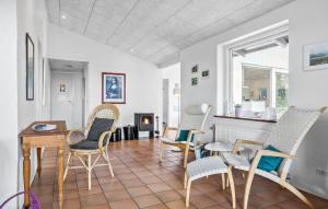 a living room with chairs and a table and a fireplace at Lovely Home In Hurup Thy With Wifi in Sindrup