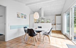 a kitchen and dining room with a white table and chairs at Lovely Home In Hurup Thy With Wifi in Sindrup