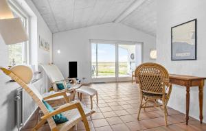 a dining room with chairs and a table and a window at Lovely Home In Hurup Thy With Wifi in Sindrup