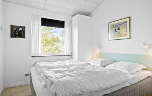 a large bed in a white room with a window at Lovely Home In Hurup Thy With Wifi in Sindrup +21 photos