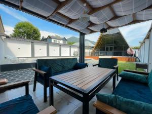 a patio with a wooden table and chairs at Qafqaz Wooden Chalet in Gabala