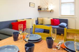 a living room with a table with plates and wine glasses at Apartmány Rokytka u sjezdovky in Rokytnice nad Jizerou