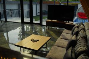 a living room with a couch and a coffee table at Qafqaz Wooden Chalet in Gabala