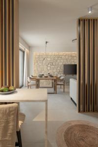 a kitchen and living room with a table and chairs at Piccadill Luxury Villas in Methoni
