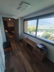 a room with a large window and a wooden floor at Appartamento la vista 2 CIR 0110 in Aosta
