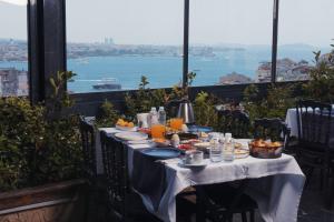 a table with food and a view of the water at Trip Bosphorus Taksim Hotel in Istanbul