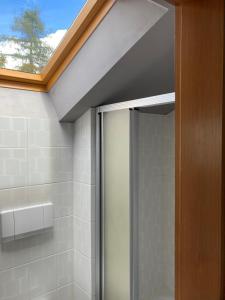 a bathroom with a shower with a glass door at Ferienhaus Valentin in Oberammergau in Oberammergau +18 photos