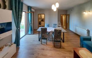 a living room with a dining room table and chairs at 1 Bedroom Awesome Apartment In Vrboska in Vrboska