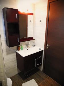 a bathroom with a sink and a mirror at Konstantinos Luxury Residence Nikiti in Nikiti