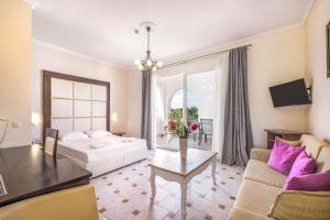 a living room with a couch and a table at Tresor Sousouras in Hanioti +66 photos