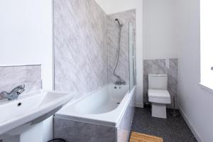 a bathroom with a sink and a tub and a toilet at Maritime House Two - 4BR Sleeps 10 Near City Centre in Hull