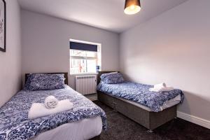 a bedroom with two beds and a window at Maritime House Two - 4BR Sleeps 10 Near City Centre in Hull