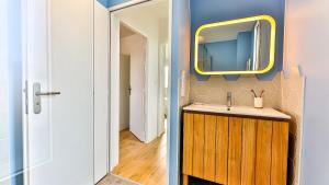 a bathroom with a sink and a mirror at Villa des Loups de Mer in Talmont +31 photos