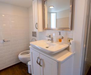a white bathroom with a sink and a toilet at Yalikavak Matilda Mega Yacth Hotel in Bodrum City +40 photos