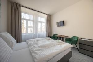 Postel nebo postele na pokoji v ubytování Hotel THT
