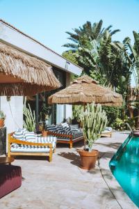 a resort with a pool and chairs and umbrellas at Villa Balfour in Eilat