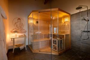 a shower with a glass enclosure in a bathroom at Ferienhof Schnurrum in Emmelsbüll-Horsbüll +111 photos