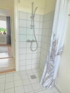 a shower with a shower curtain in a bathroom at Apartment in Denmark - Hygge Villa in Otterup +34 photos