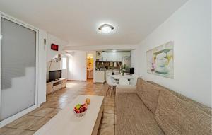 a living room with a couch and a table at 2 Bedroom Gorgeous Home In Hodilje in Hodilje