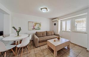 a living room with a couch and a table at 2 Bedroom Gorgeous Home In Hodilje in Hodilje