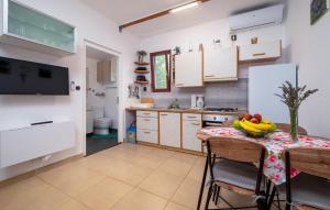 a kitchen with a table with bananas on it at Stunning Home In Kavran With Wifi in Kavran