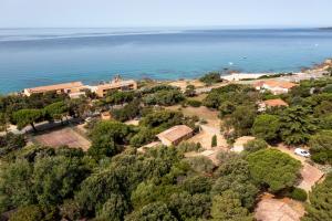 an aerial view of a house next to the water at Villas Abbartello in Olmeto