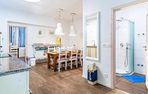 a kitchen and dining room with a table and a dining room at Lovely Apartment In Fazana With Wifi in Fažana