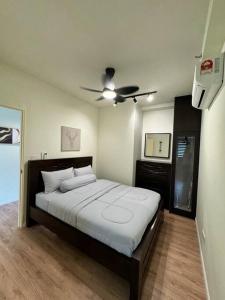 a bedroom with a bed with a ceiling fan at SY Urban Dwell Staycation Near Shah Alam Stadium in Shah Alam
