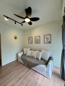 a living room with a couch and a ceiling fan at SY Urban Dwell Staycation Near Shah Alam Stadium in Shah Alam +27 photos