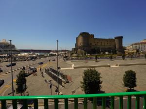 a view of a city with a castle in the background at NAP Luxury Guest House Municipio in Naples