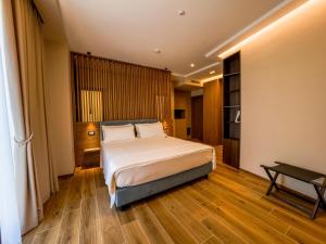a bedroom with a large bed and a wooden floor at NAP Luxury Guest House Municipio in Naples