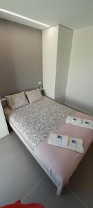 a bedroom with a bed with two price tags on it at Casa do Castelo in Gafanha da Nazaré