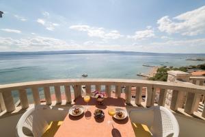 a table with food and drinks on a balcony at Villa Nada - room for 2 in Duće