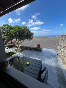 a patio with a table and a view of the ocean at Casa El Mirador B in Mácher