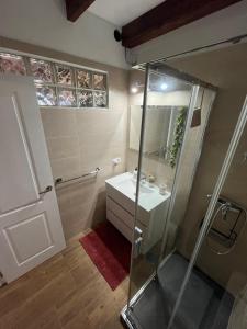a bathroom with a glass shower and a sink at Casa El Mirador B in Mácher +7 photos