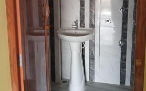 a bathroom with a white sink in a room at Bonmoyuri Sudarban by StayApart in Japur