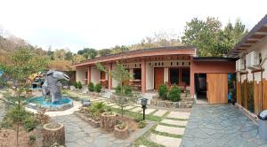 a house with a statue of an elephant in front of it at Alffiah Hotel in Bonto